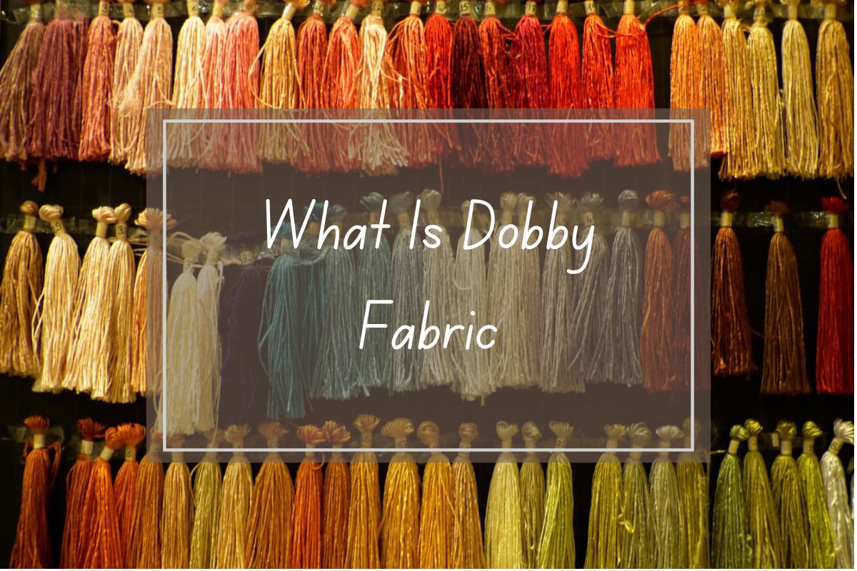 Colorful threads, tassels, and a graphic overlay reading "What is Dobby Fabric".